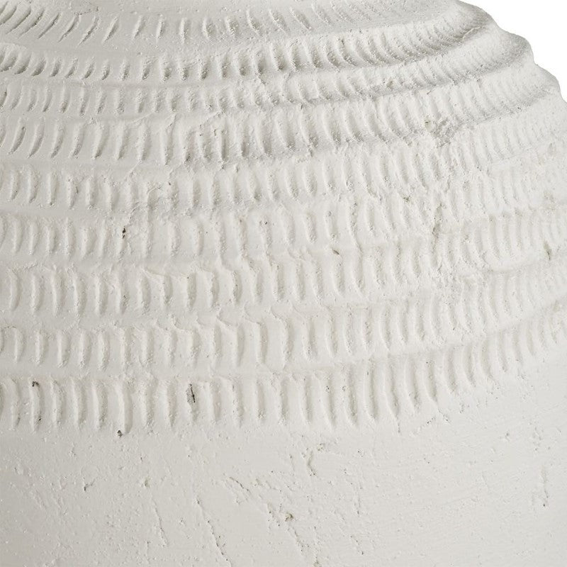 Close-up of carved ribbed texture on white vase