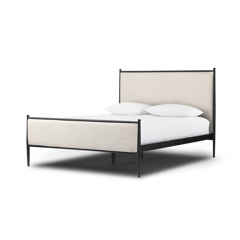Xander upholstered iron bed with a textured black iron frame, ball-topped tapered legs, and a cream headboard.